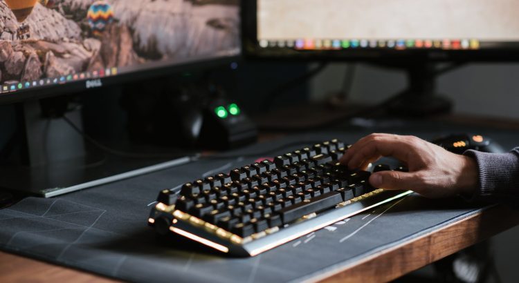 crop unrecognizable man typing on modern computer keyboard